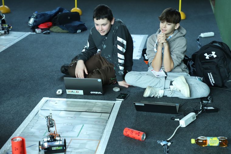 A student team building and programming a robot together